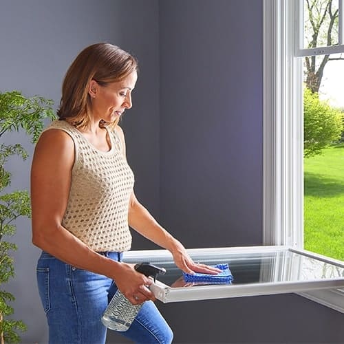 woman cleaning window