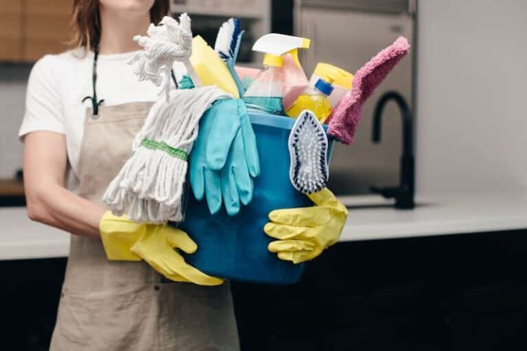 woman holding cleaning supplies