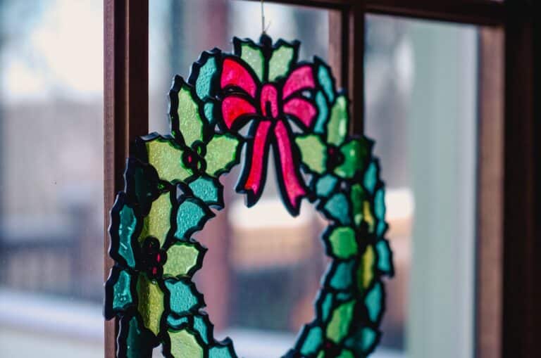stained glass holiday wreath in window